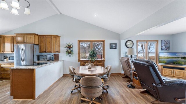 kitchen with wood finished floors, open floor plan, and stainless steel appliances