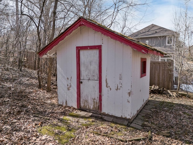 view of shed featuring fence