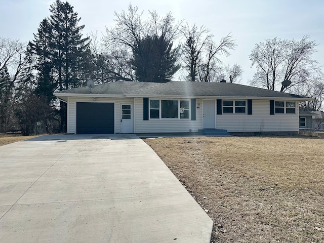 ranch-style home featuring an attached garage and driveway