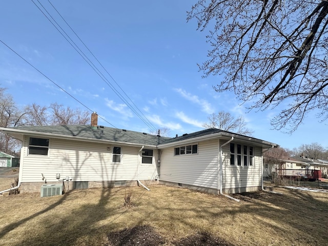 rear view of property with a yard and a chimney