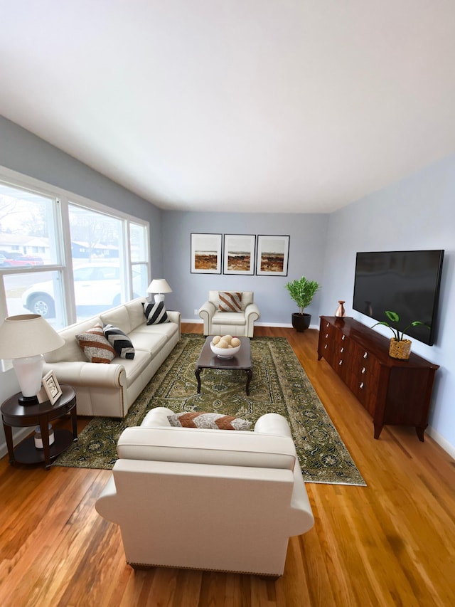 living room with baseboards and wood finished floors