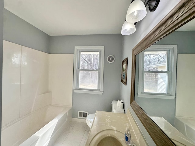 full bathroom with visible vents, baseboards, toilet, tile patterned floors, and vanity