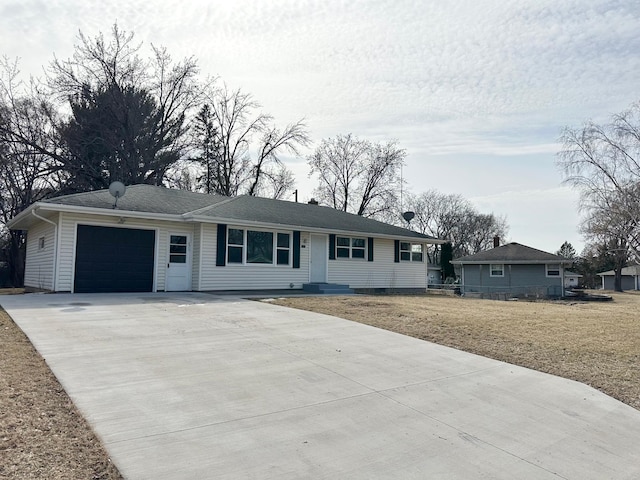 ranch-style house with an attached garage, concrete driveway, a front yard, and fence