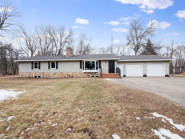 ranch-style home featuring aphalt driveway, a front lawn, a chimney, and a garage