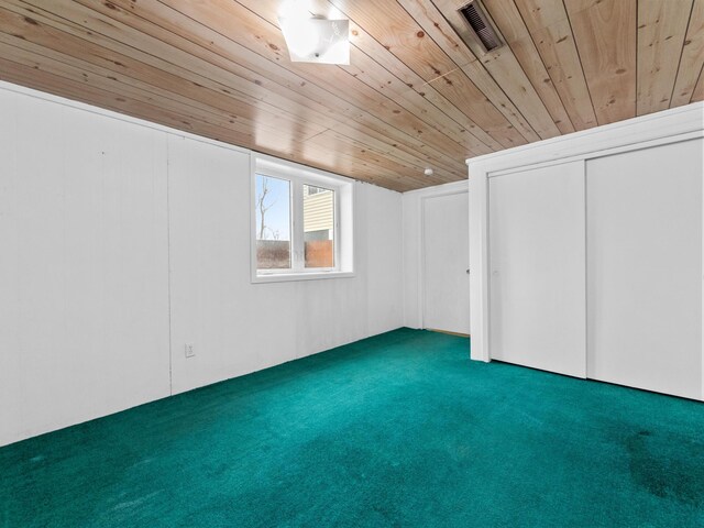 interior space featuring visible vents, carpet flooring, and wood ceiling