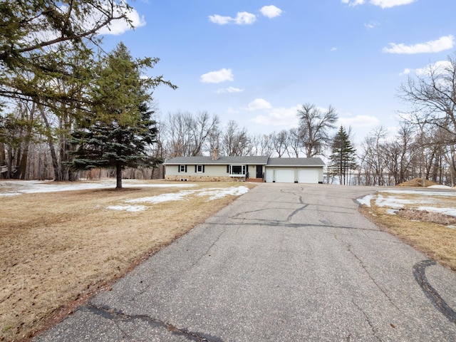 single story home featuring an attached garage and driveway