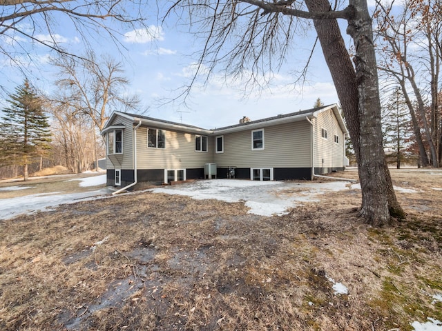 rear view of property with a chimney