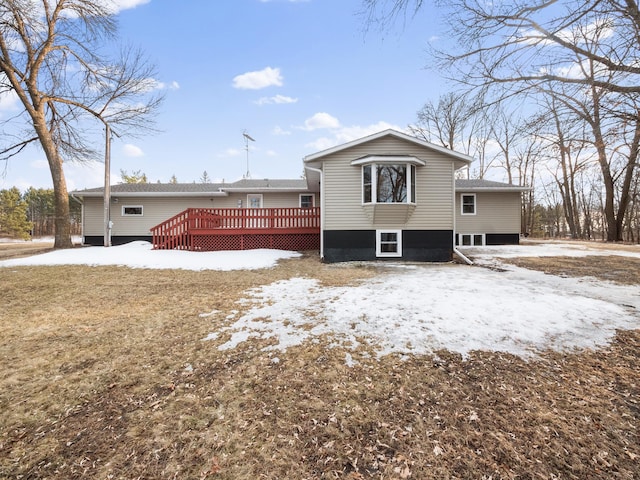 snow covered property featuring a deck