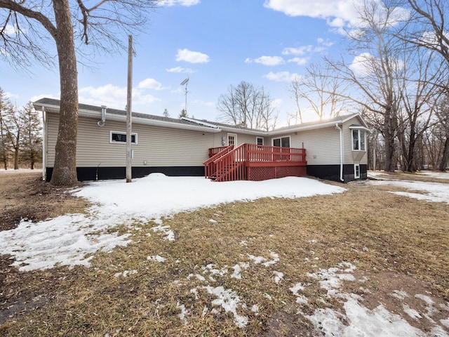 snow covered property with a wooden deck