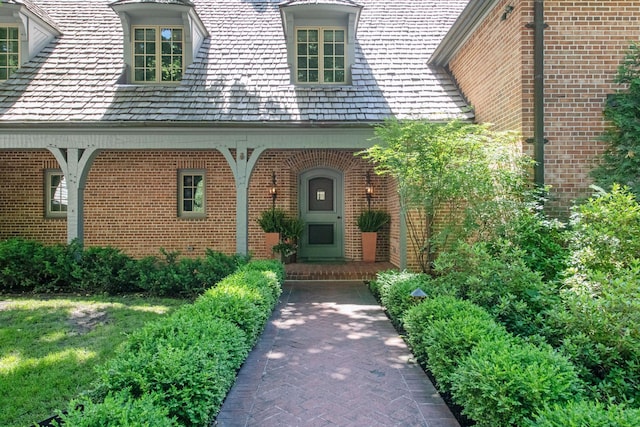 view of exterior entry with brick siding