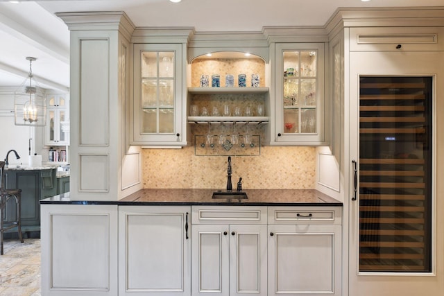 bar with beverage cooler, backsplash, indoor wet bar, and a sink