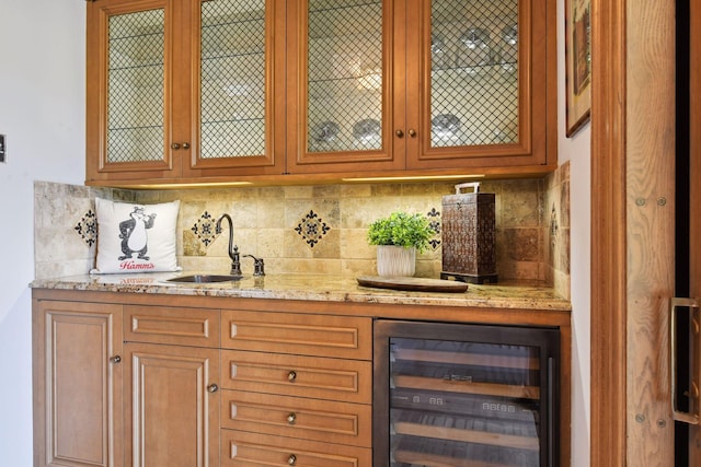 bar with a sink, decorative backsplash, wine cooler, and bar area