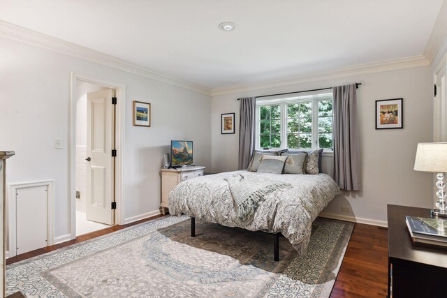 bedroom with baseboards, dark wood finished floors, and crown molding