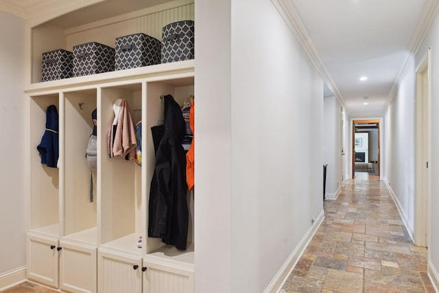 mudroom with stone tile floors, recessed lighting, crown molding, and baseboards