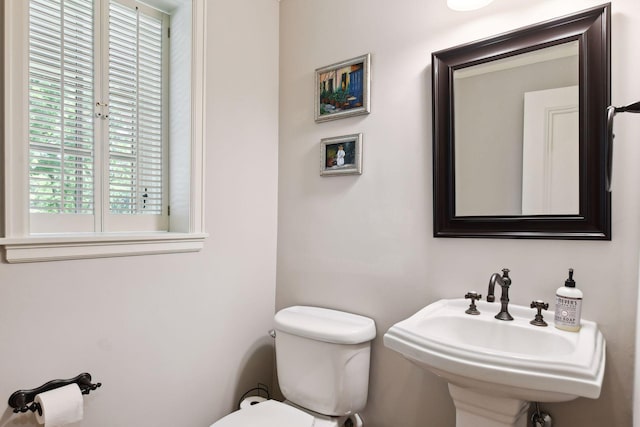 half bath featuring a sink and toilet