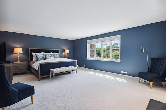 carpeted bedroom featuring baseboards