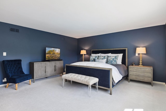 bedroom featuring visible vents, baseboards, and light colored carpet