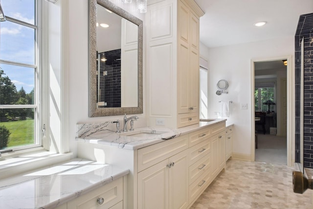 bathroom featuring a sink, recessed lighting, and double vanity