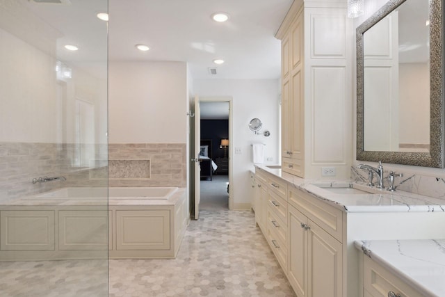 bathroom featuring visible vents, vanity, a garden tub, recessed lighting, and ensuite bath