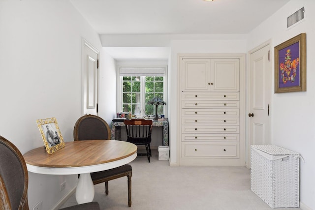 dining area featuring light carpet and visible vents