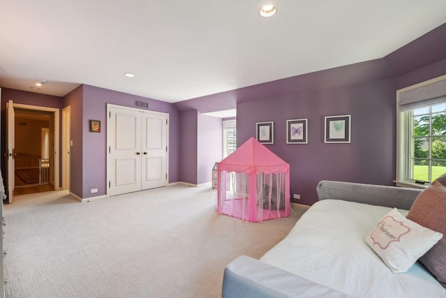 bedroom with visible vents, recessed lighting, a closet, baseboards, and light colored carpet