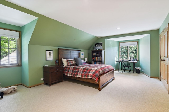 carpeted bedroom with baseboards, multiple windows, and vaulted ceiling