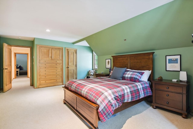 bedroom featuring recessed lighting, light colored carpet, and lofted ceiling