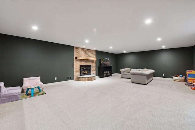 living room featuring recessed lighting, baseboards, and a fireplace