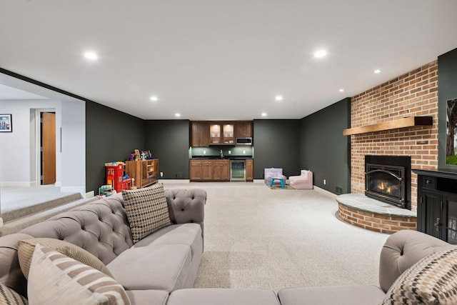 carpeted living room featuring recessed lighting, a fireplace, and baseboards