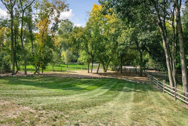 view of yard with a rural view and fence