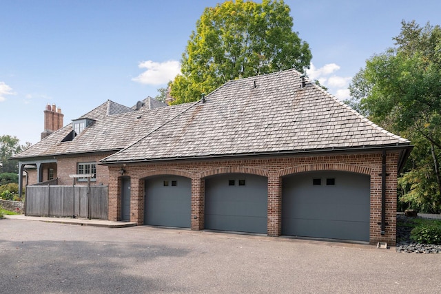 view of home's exterior with a garage and brick siding