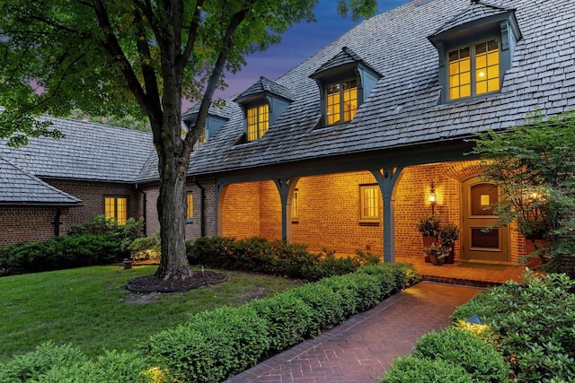 view of front facade featuring brick siding and a front yard