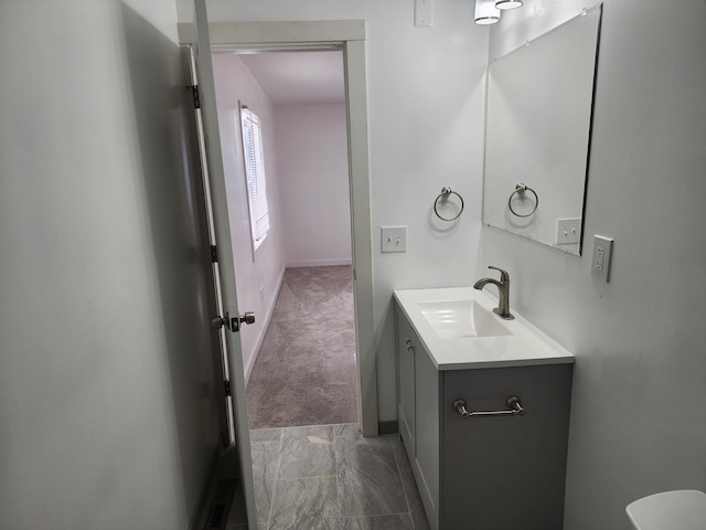 bathroom with visible vents, baseboards, marble finish floor, and vanity