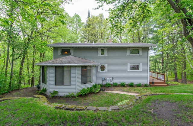 view of front of home with a front yard and a chimney