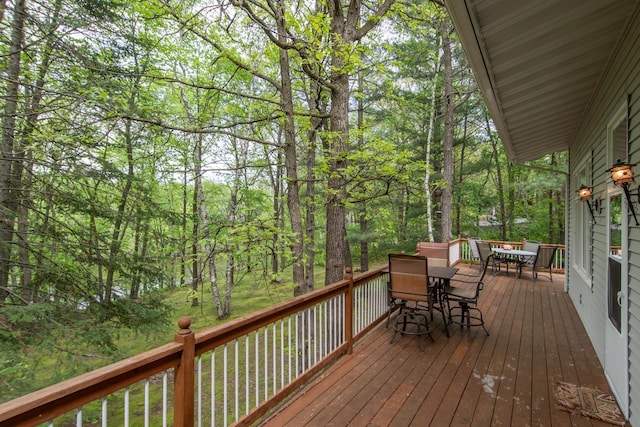 wooden terrace with outdoor dining space