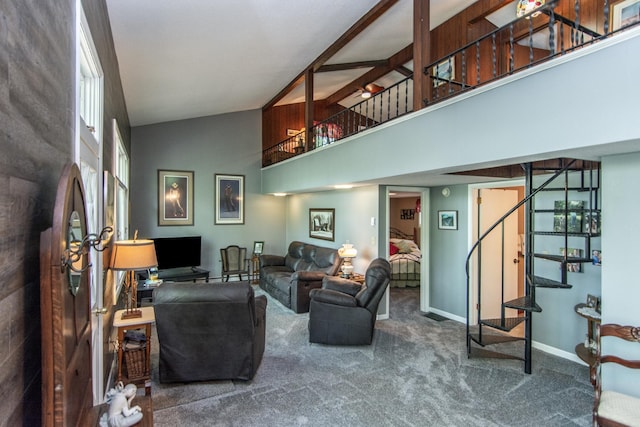 living area featuring carpet floors, stairway, baseboards, and high vaulted ceiling