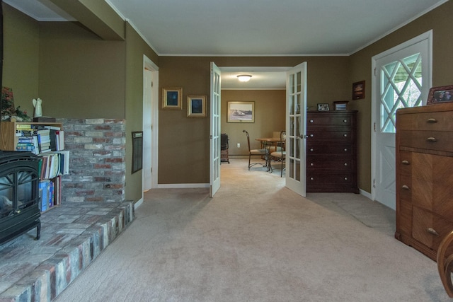 hallway with light carpet, baseboards, crown molding, and french doors