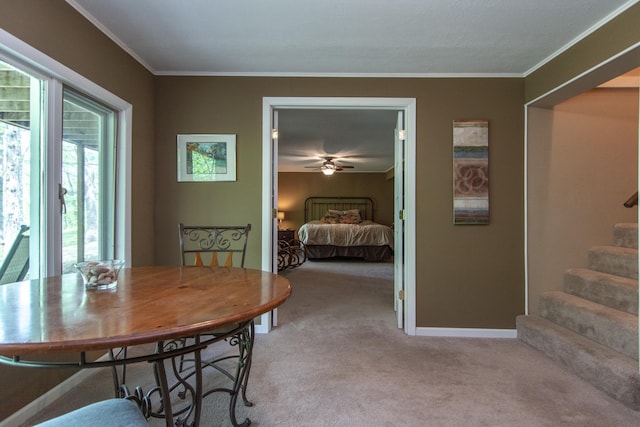 dining area with light carpet, crown molding, baseboards, and stairs