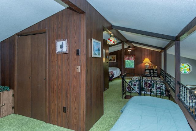 carpeted bedroom featuring wood walls, lofted ceiling with beams, and a textured ceiling