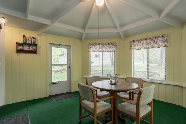 carpeted dining space featuring vaulted ceiling with beams and plenty of natural light