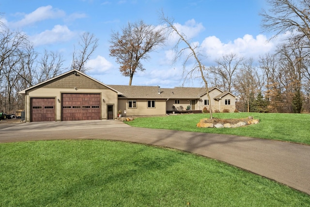 single story home with a garage, concrete driveway, and a front lawn