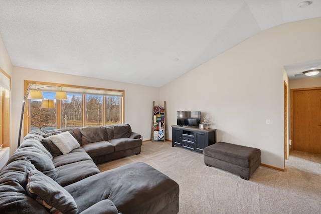 living area with light colored carpet, a textured ceiling, baseboards, and vaulted ceiling