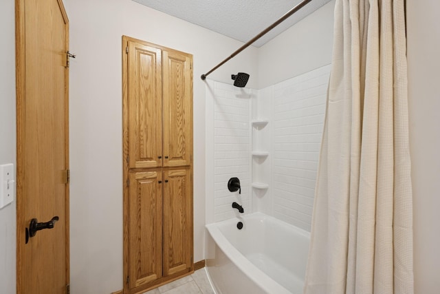 full bathroom featuring tile patterned floors, shower / bathtub combination with curtain, and a textured ceiling