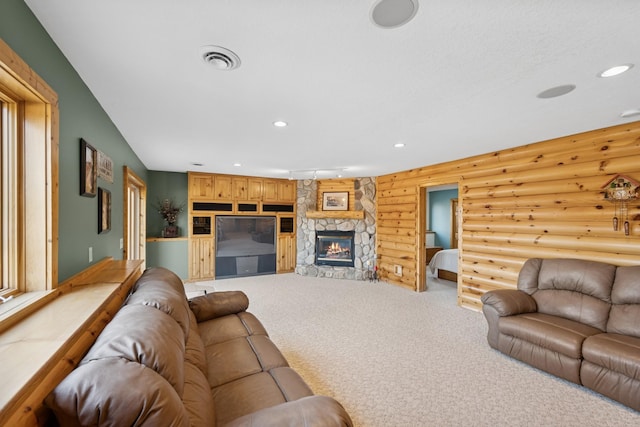 living area featuring light carpet, recessed lighting, a fireplace, and log walls