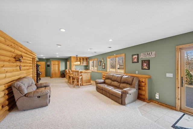 living area with light carpet, recessed lighting, a bar, log walls, and baseboards