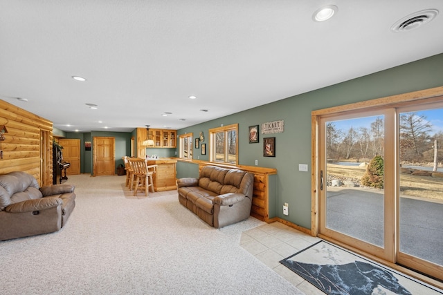 living room with visible vents, light carpet, recessed lighting, a bar, and baseboards