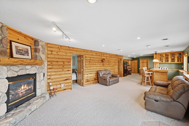 living area featuring a stone fireplace, recessed lighting, light colored carpet, and rustic walls