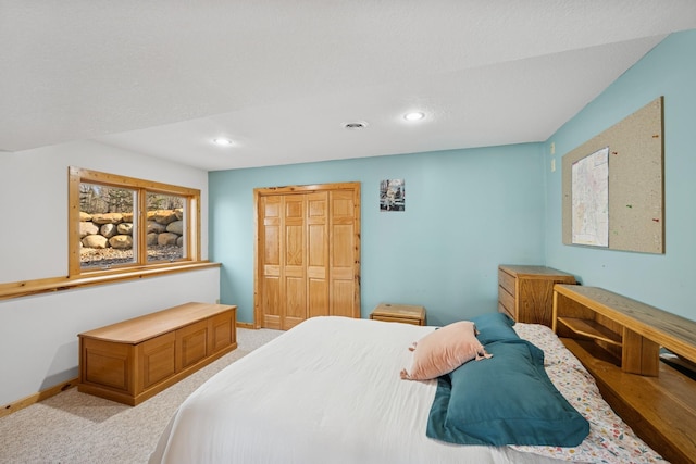 bedroom featuring recessed lighting, a closet, baseboards, and light carpet