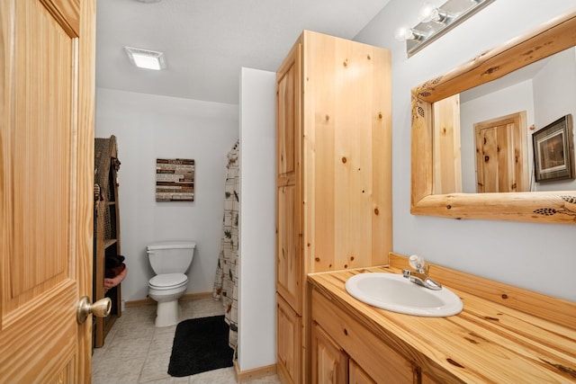 bathroom featuring tile patterned floors, visible vents, toilet, baseboards, and vanity