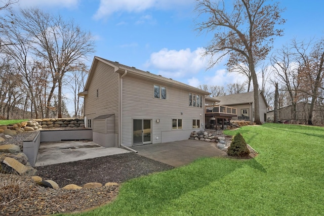 back of house featuring a yard, a patio area, and a wooden deck